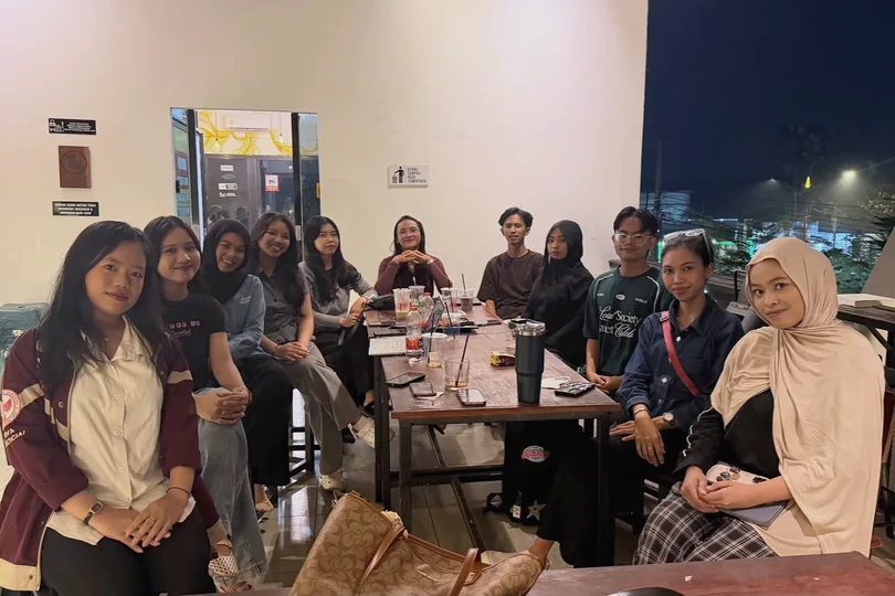 A group gathered around a table in the evening.