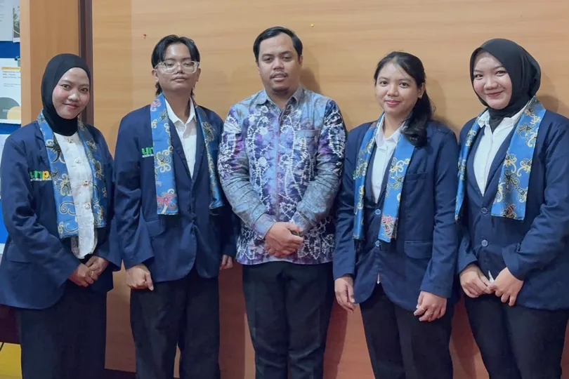 Group documentation with university blazers indoors.