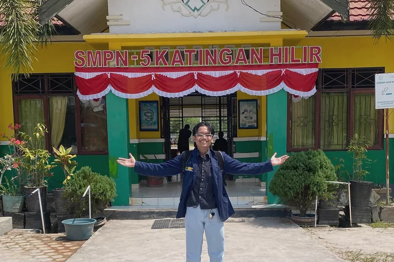 William standing in front of the school entrance.