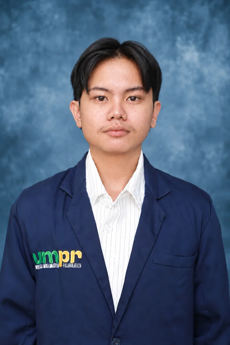 William Hans Permana wearing a navy Universitas Muhammadiyah Palangka Raya blazer against a blue studio backdrop